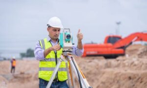 Surveyor conducting a land survey before construction begins on a development site